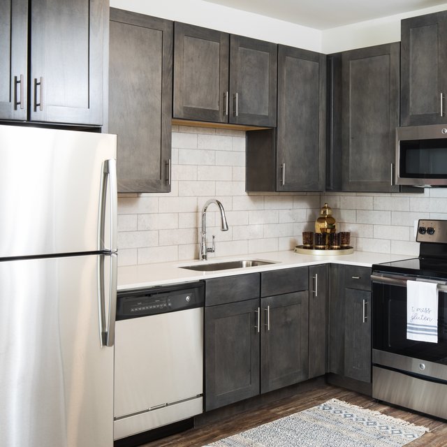 Upgraded Kitchen with Stainless Steel  Appliances, Quartz Counter Tops, and Tiled Backsplash